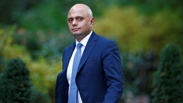 British secretary of state Sajid Javid looks to the camera with a stern expression as he arrives at 10 Downing Street