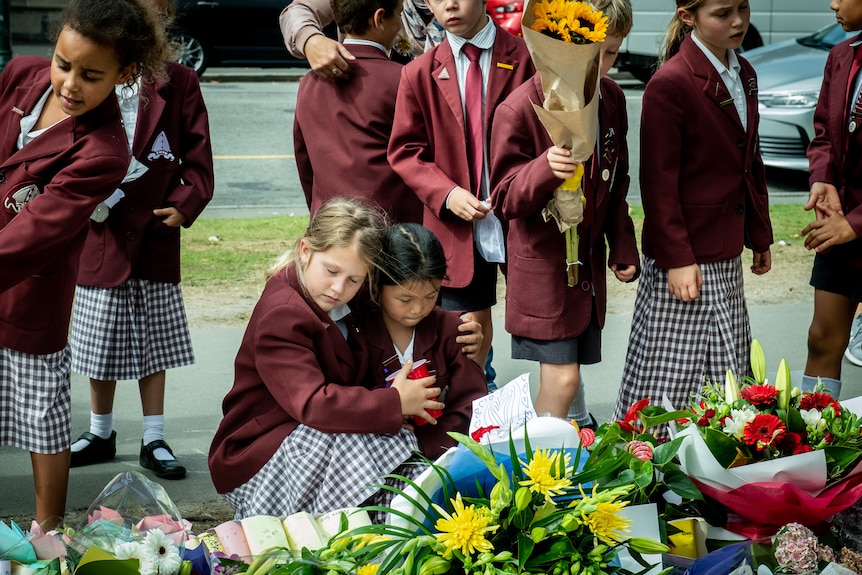 Children lay flowers after Christchurch terror attack in 2019