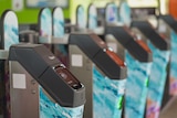 A row of turnstiles with electronic tap function at Queensland train station