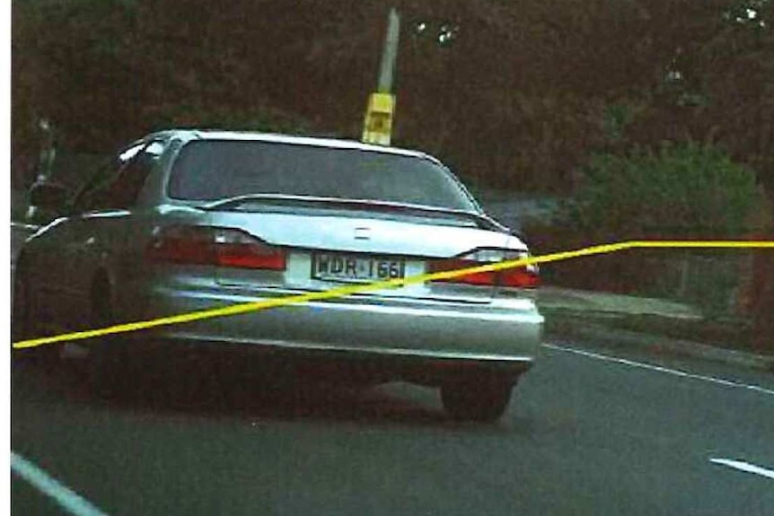 A car driving on a road in a speed camera image
