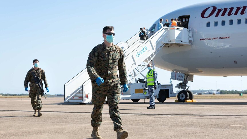 The first 200 US Marines from the 2020 Marine Rotational Force arrive in Darwin wearing face masks.