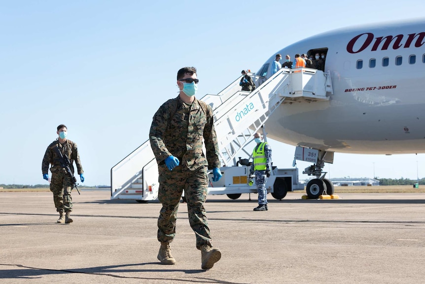 The first 200 US Marines from the 2020 Marine Rotational Force arrive in Darwin wearing face masks.