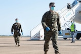 The first 200 US Marines from the 2020 Marine Rotational Force arrive in Darwin wearing face masks.