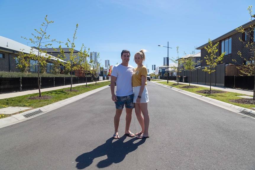 Daniel Mackertich and Melissa Kolbe standing in a street in the new suburb of Cloverton, Victoria.