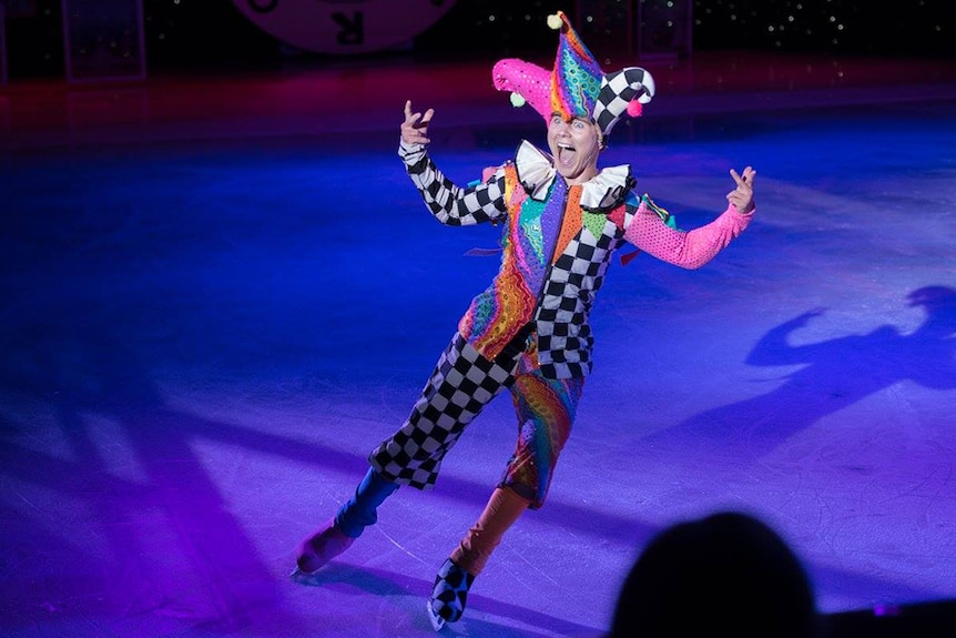 Ice skater Roman Khitiaev performing on ice dressed in a jester costume