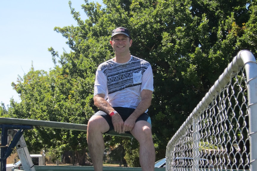 Sergeant Jason Doig sitting on a dunking machine.