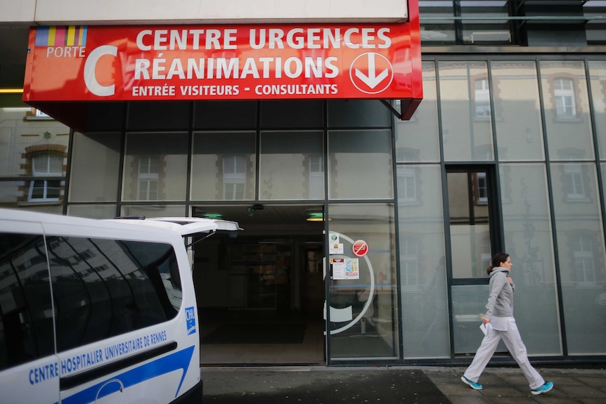 An ambulance at the CHU de Rennes Hospital in France where six people are in a serious condition after a drug trial