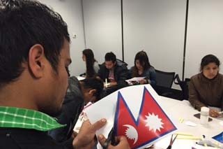 Nepalese students make flags at the University of Tasmania in Hobart.