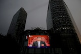 Screen shows news footage of Chinese President Xi Jinping at the closing session of NPC in Beijing.