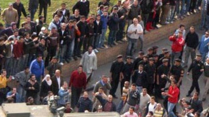 A police van is halted at a protest of thousands of Egyptians in central Cairo