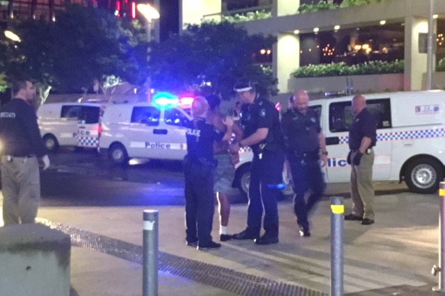 A man is arrested outside the ABC headquarters in South Bank, Brisbane