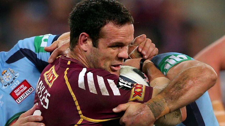 Maroons Nate Myles is tackled during game three of the State of Origin series in Brisbane.