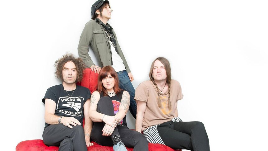The Dandy Warhols posing on a couch