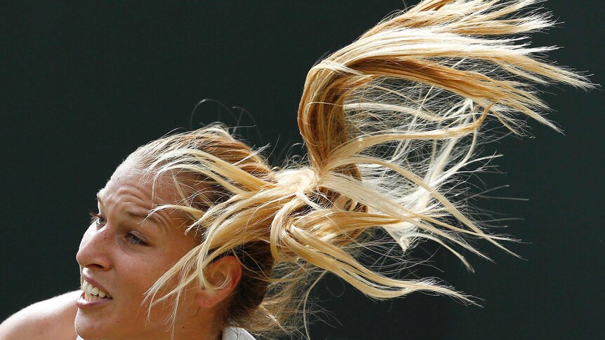 Dominikia Cibulkova serves to Lucie Safarova during their match at Wimbledon.