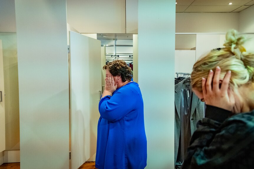 Heidi Arntzen holds her head in dismay as she sees how a top she's tried on fits her, in a Bendigo shop.
