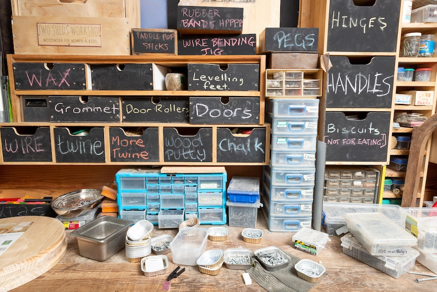 colorful drawers on a bench with metal containers of screws lying below