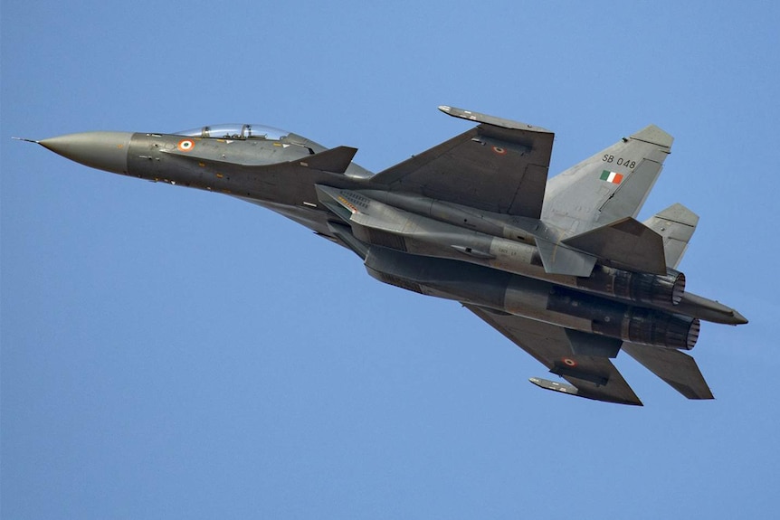 A photo of an Indian Airforce Sukoi SU-30MKI against a backdrop of clear blue sky.