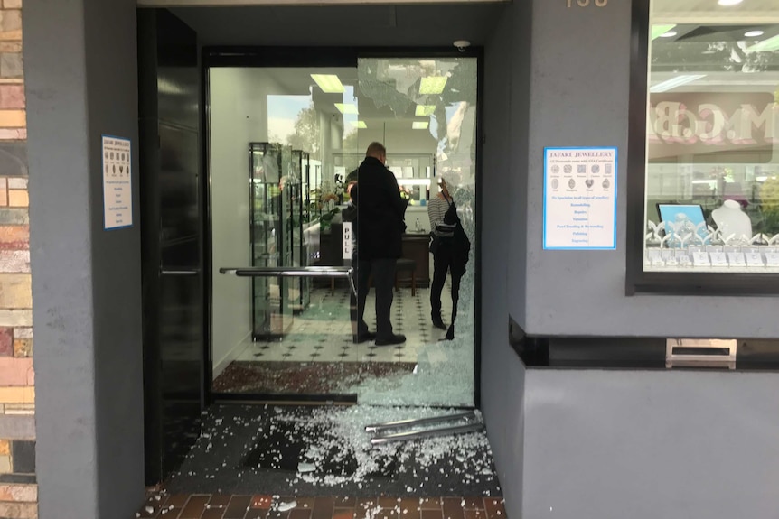 The glass door of a jewellery store in Malvern is shattered after a robbery.