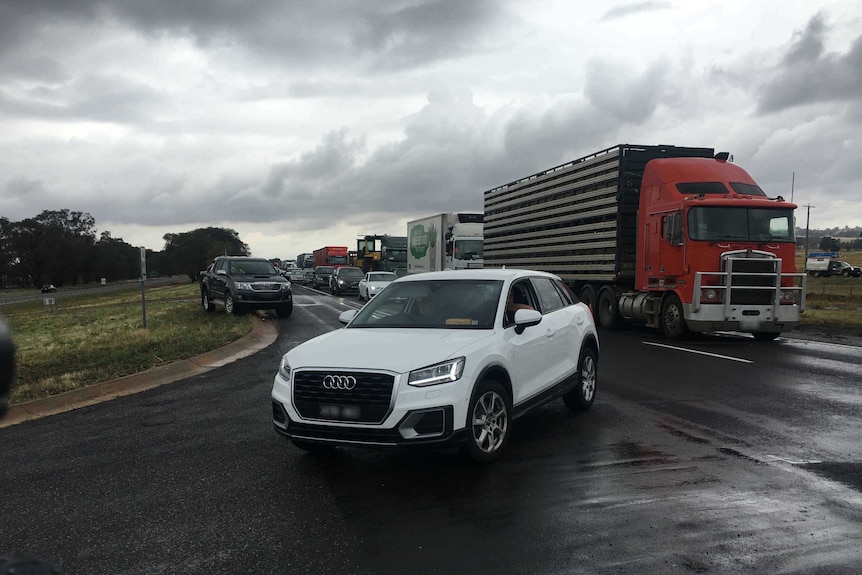 Traffic at a stand still on the Hume Freeway as a police officer directs traffic.