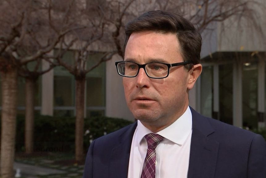 A man in a suit at Parliament House.