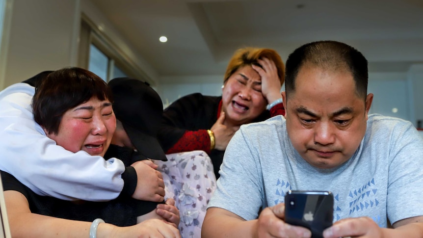Dillon Wu's mother, sister, aunty cry at their dining table, while Dillon's dad stares at his phone.