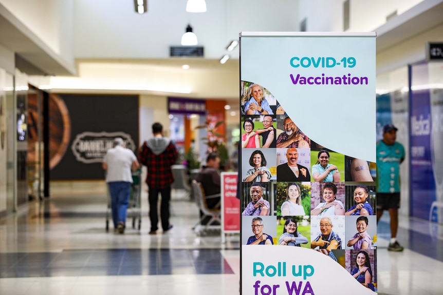 A sign promoting COVID-19 vaccines in a shopping centre.