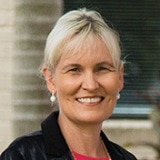 Stock image of woman standing and smiling at camera