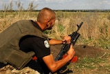 Ukrainian serviceman shooting a grenade