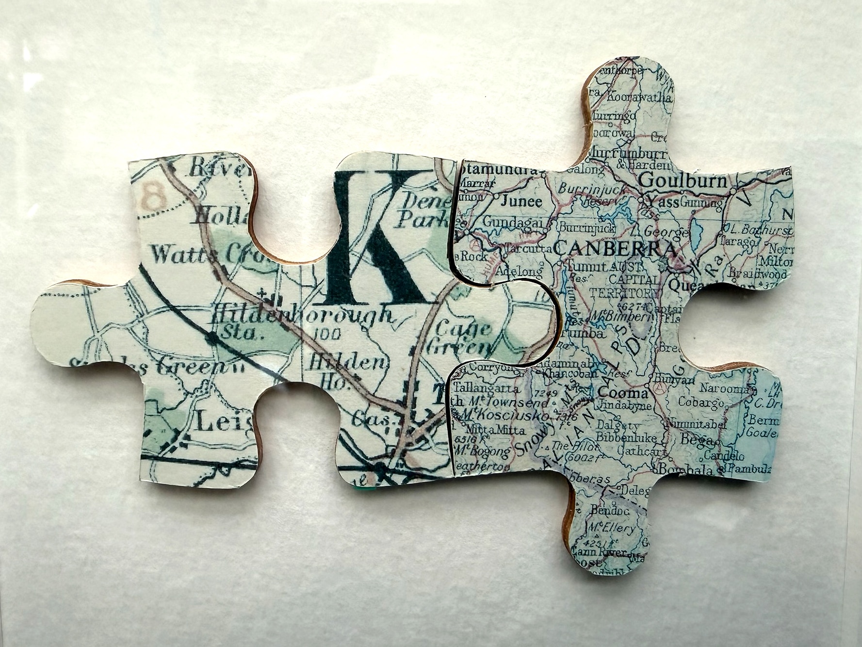 Two maps fashioned into two complementary jigsaw pieces