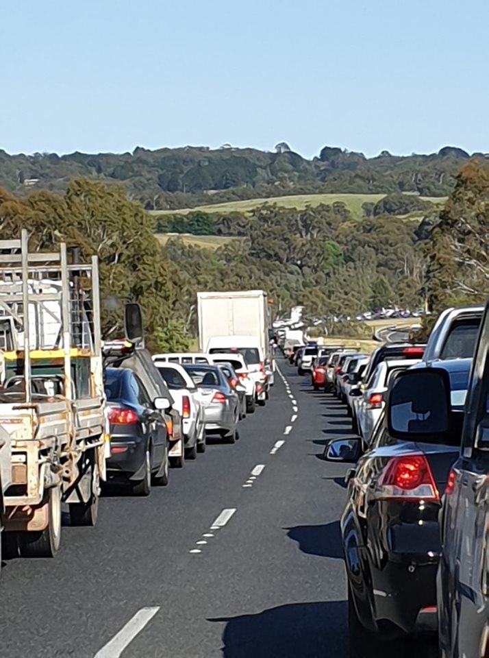 A line of cars and other vehicles caught in a traffic jam.