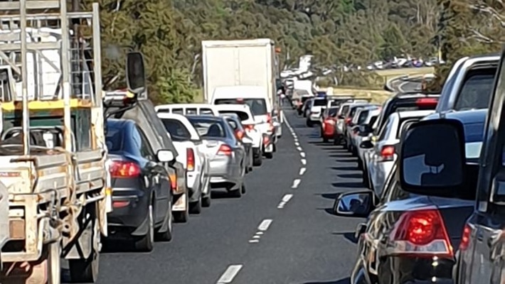 A line of cars and other vehicles caught in a traffic jam.