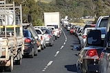 A line of cars and other vehicles caught in a traffic jam.