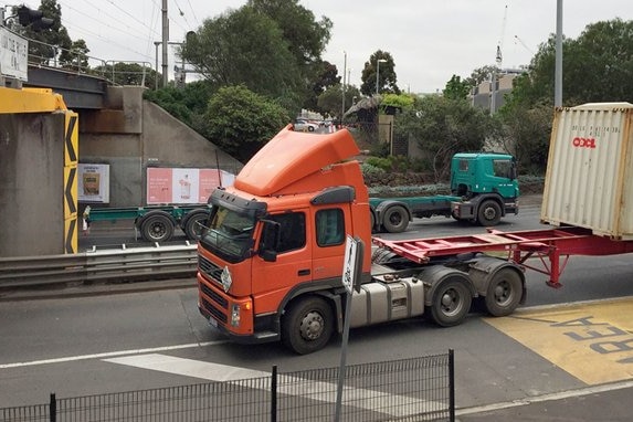 A truck sits on Napier Street after its container hit the 4m high bridge.