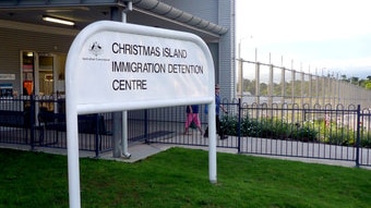 Immigration workers walk past the front door of the Christmas Island detention centre on April 14, 2010. (Hayden Cooper/ABC N...