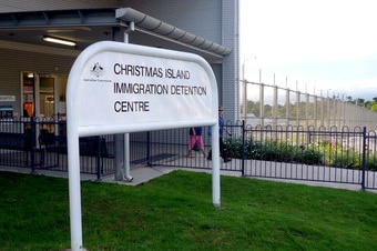 Immigration workers walk past the front door of the Christmas Island detention centre on April 14, 2010. (Hayden Cooper/ABC N...