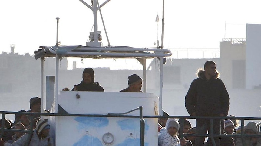 A fishing boat with illegal immigrants from Tunisia arrives on Lampedusa