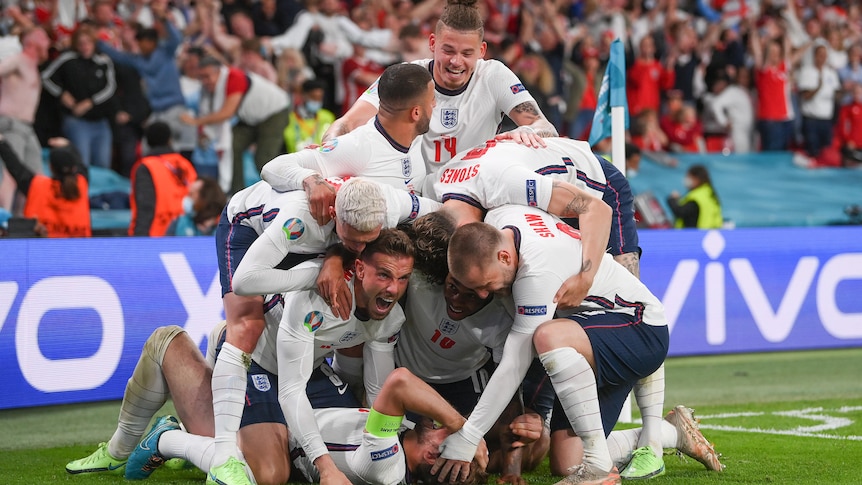 A number of England players pile on top of Harry Kane in celebration