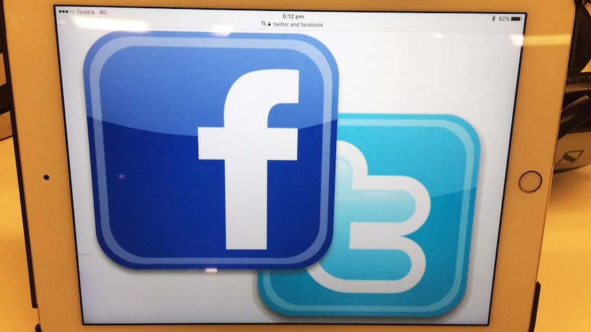 Facebook and Twitter icons on an iPad screen