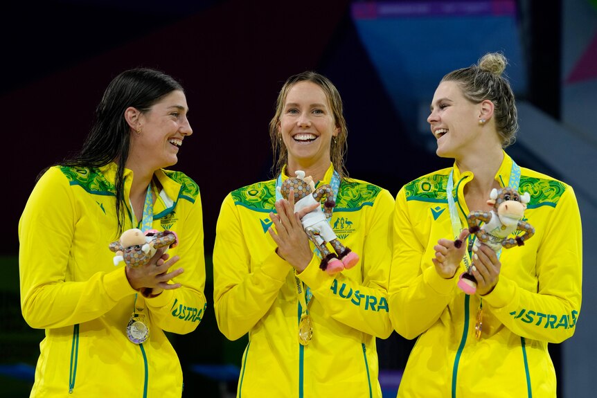 meg harris emma mckeon and shayna jack clap and laugh during medal ceremony