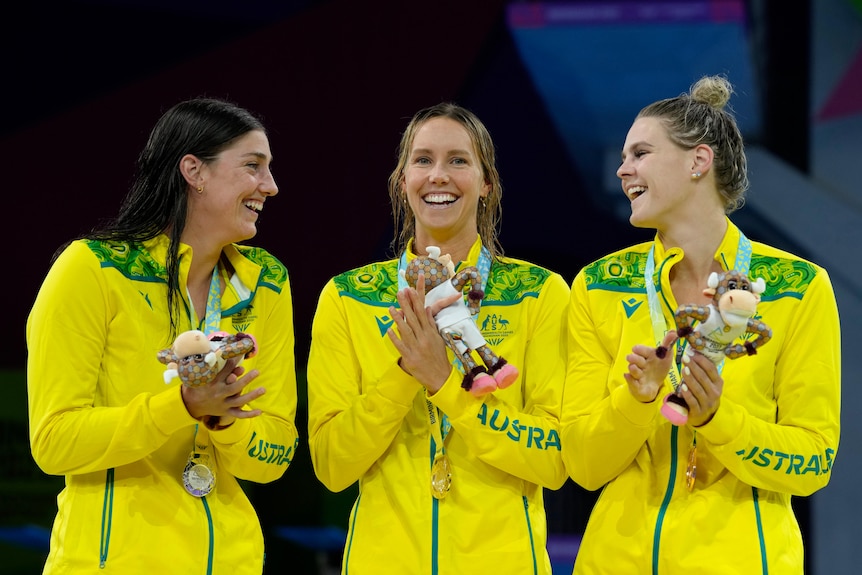 meg harris emma mckeon and shayna jack clap and laugh during medal ceremony
