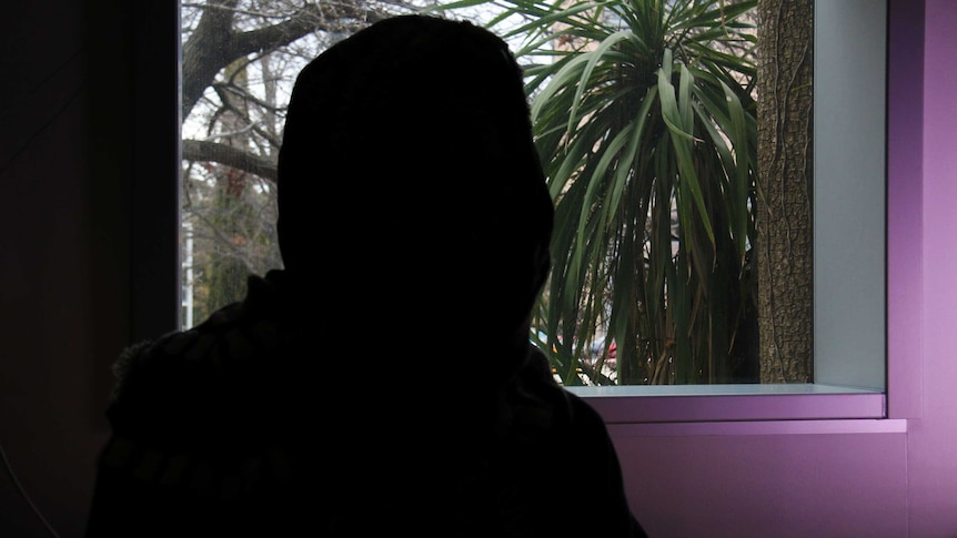The silhouette of an unidentifiable woman.