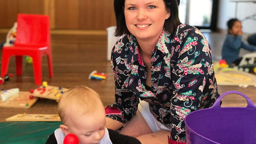 Talitha Vuillemot and her son Orson play on the floor at playgroup at Fitzgibbon Chase's Community Centre.