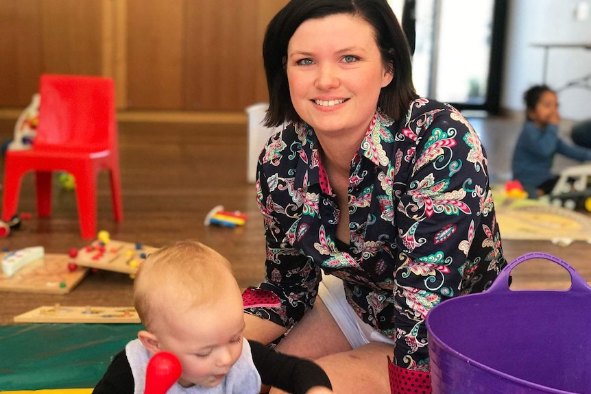 Talitha Vuillemot and her son Orson play on the floor at playgroup at Fitzgibbon Chase's Community Centre.