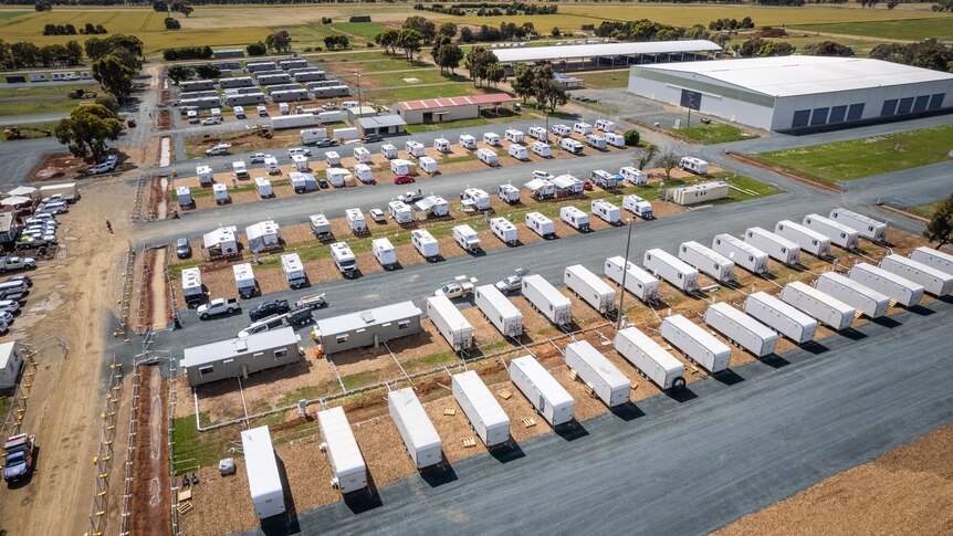 A drone photo of caravans neatly set in a large field.