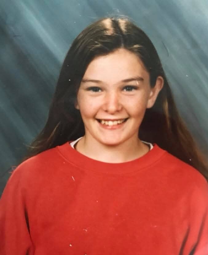 A girl smiling in a school photo