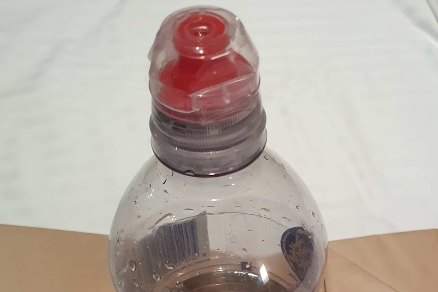 A half empty drink bottle containing a clear liquid