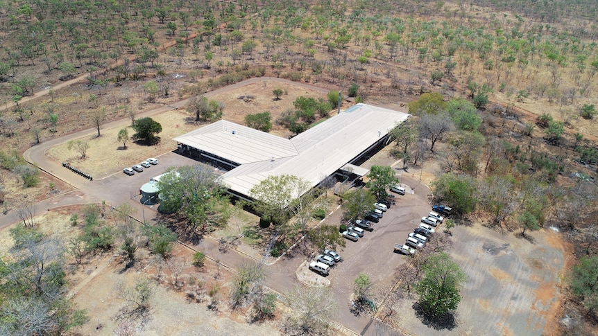Aerial image of a building surrounded by cars