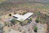 Aerial image of a building surrounded by cars
