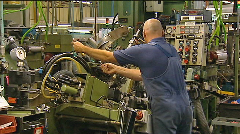 Interior of ACL Bearing company, Launceston, worker at machinery.