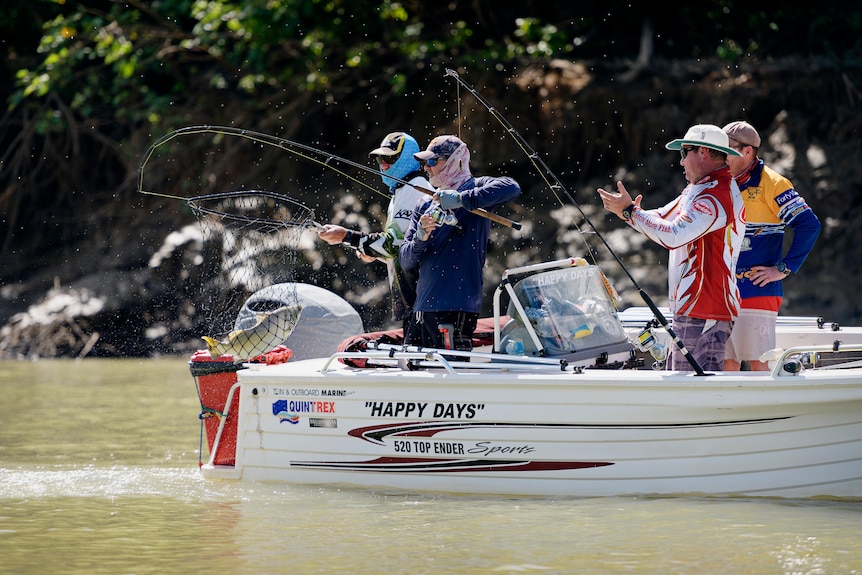 Fishos reel in a barra on the Daly River.